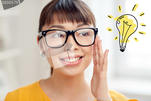 Image of asian woman in glasses with light bulb doodle