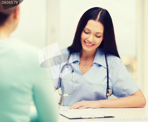 Image of smiling doctor or nurse with patient