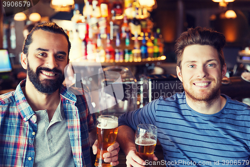 Image of happy male friends drinking beer at bar or pub