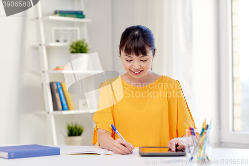 Image of asian woman student with tablet pc at home