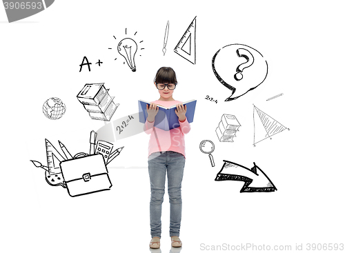 Image of happy little girl in eyeglasses reading book