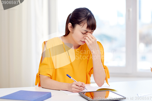 Image of tired asian woman student with tablet pc at home