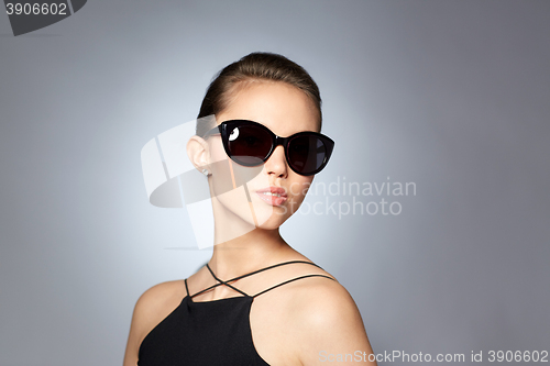 Image of beautiful young woman in elegant black sunglasses