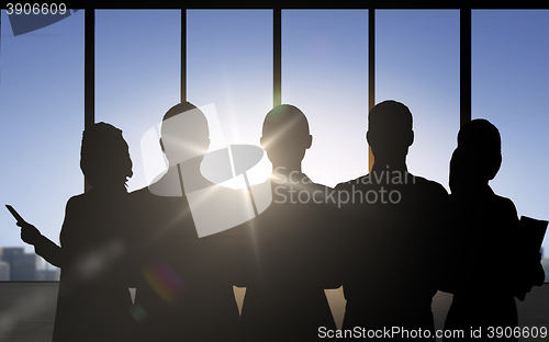 Image of business people silhouettes over office background