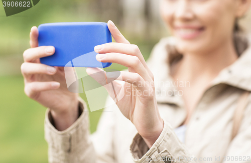 Image of close up of woman taking picture with smartphone