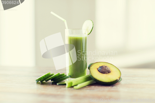 Image of close up of fresh green juice glass and vegetables