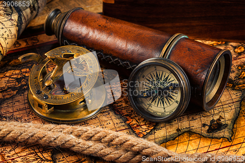 Image of Old vintage compass and navigation instruments on ancient map