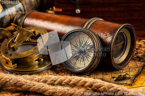 Image of Old vintage compass and navigation instruments on ancient map