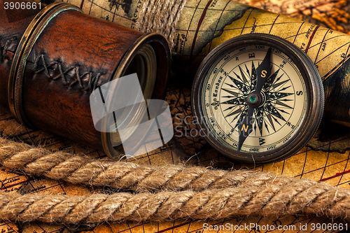 Image of Old vintage compass and navigation instruments on ancient map