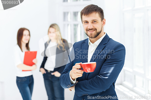 Image of Young colleagues having coffee break in office