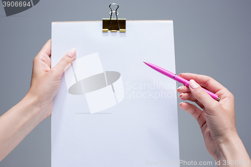 Image of The notepad and pen in female hands