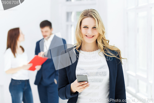 Image of Portrait of businesswoman talking on phone in office