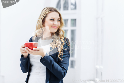 Image of The female office worker having coffee break 