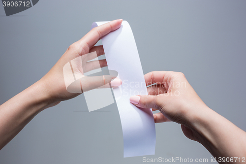 Image of The female hands with  empty transaction paper or paper check