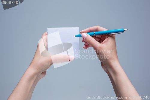 Image of The notepad and pen in female hands