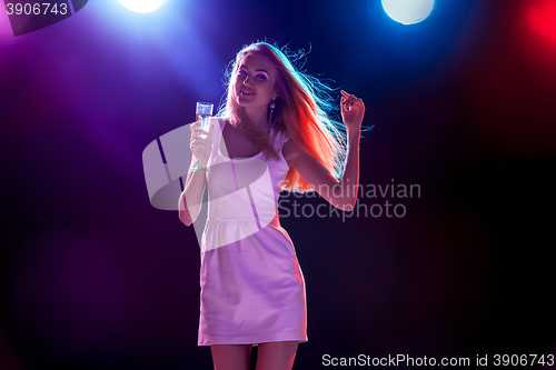 Image of The beautiful girl dancing at the party drinking champagne