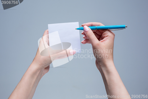 Image of The notepad and pen in female hands