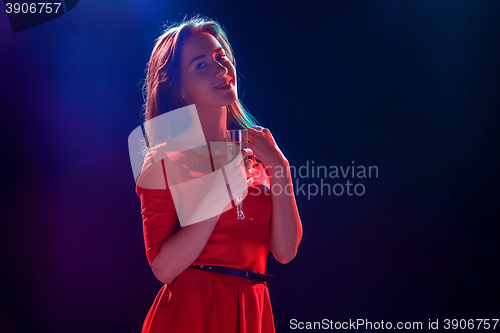 Image of The beautiful girl dancing at the party drinking champagne