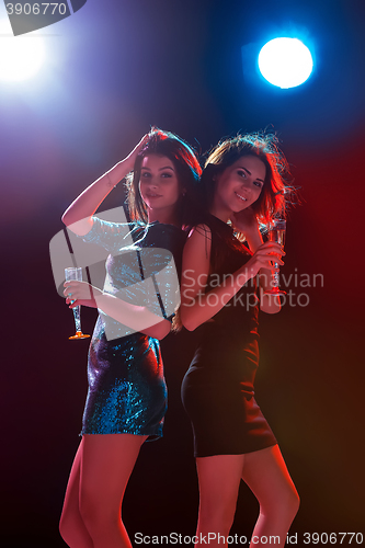 Image of Two beautiful girls dancing at the party