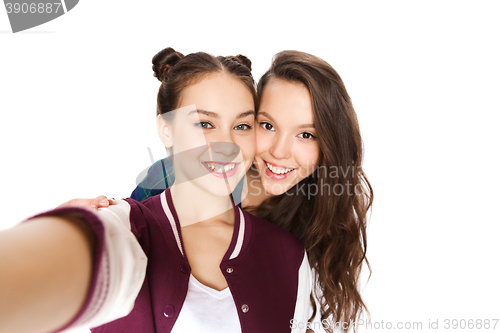 Image of happy smiling pretty teenage girls taking selfie