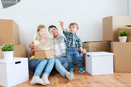 Image of happy family with boxes moving to new home