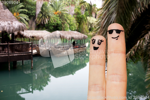 Image of close up of two fingers with smiley faces