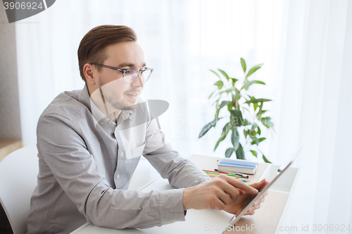 Image of happy creative male office worker with tablet pc