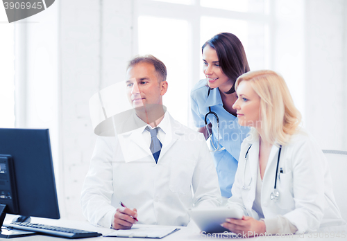 Image of doctors looking at computer on meeting