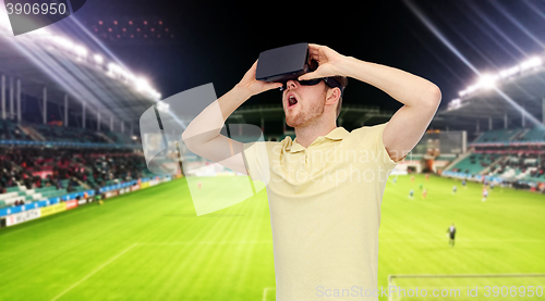 Image of man in virtual reality headset over football field