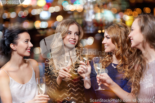 Image of happy women with champagne glasses at night club