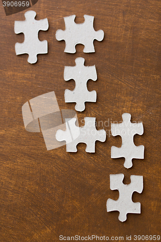 Image of close up of puzzle pieces on wooden surface