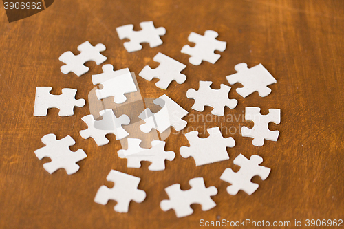 Image of close up of puzzle pieces on wooden surface