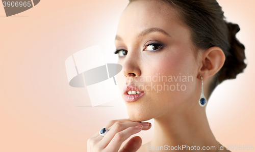 Image of beautiful woman with earring and finger ring