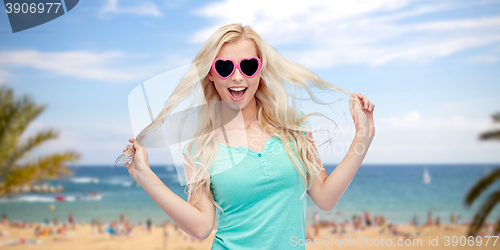 Image of happy young blonde woman or teenager in sunglasses