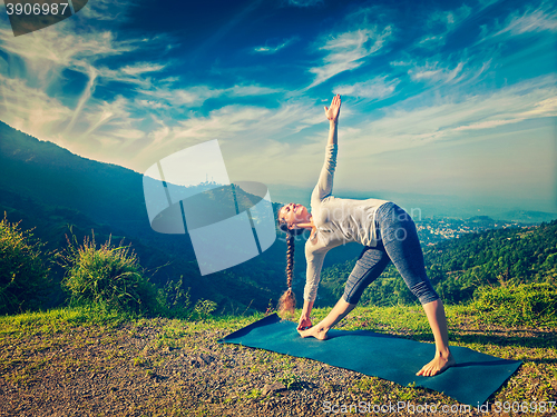 Image of Woman doing Ashtanga Vinyasa yoga asana Utthita trikonasana