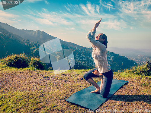 Image of Young woman doing Ashtanga Vinyasa yoga advanced asana 