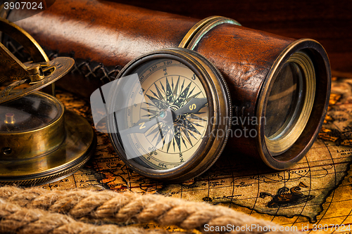 Image of Old vintage compass and navigation instruments on ancient map