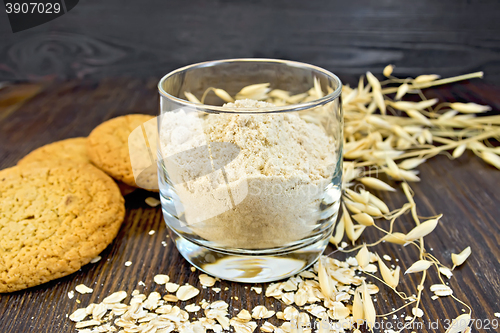 Image of Flour oat in glass with cookies on board