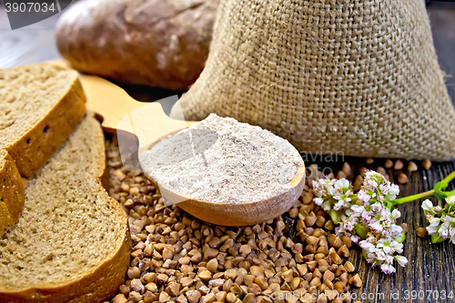 Image of Flour buckwheat in spoon with cereals and bread on board