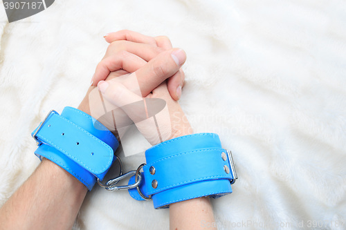 Image of Male and female hands in handcuffs. sexy couple in bed. sex Toys