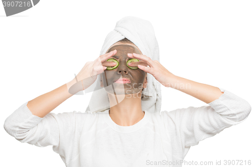 Image of Young beautiful woman in mask for the face. therapeutic black clay. Spa treatment.