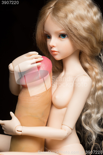 Image of concept. Doll with different sex toys.