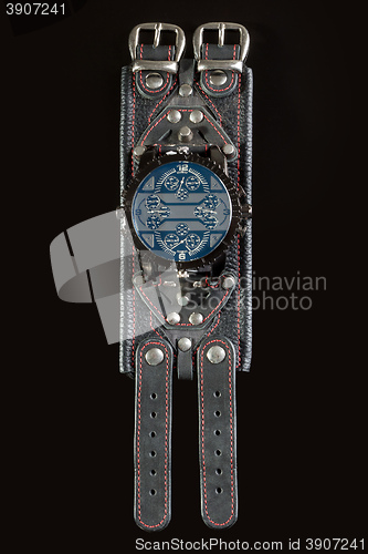 Image of close-up of wristwatch on a black background