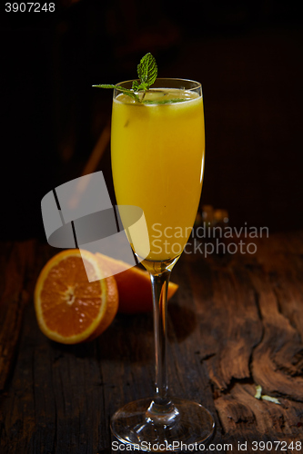 Image of Orange cocktail on rustic wooden table