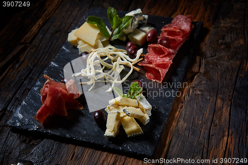 Image of Salami and cheese platter with herbs