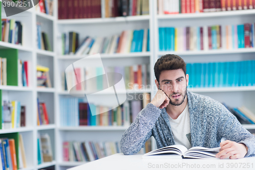 Image of portrait of student while reading book  in school library