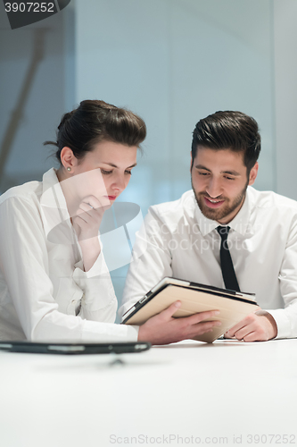 Image of young business couple working together on project