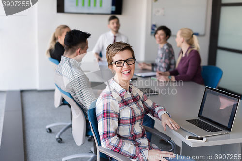 Image of portrait of young business woman at office with team on meeting 