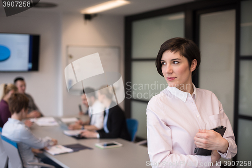 Image of hispanic businesswoman with tablet at meeting room