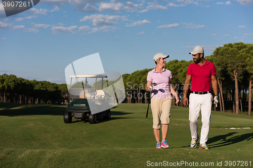 Image of couple walking on golf course